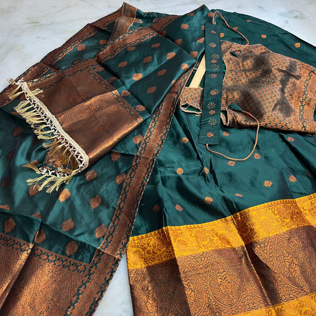 Regal emerald green lehenga set with a richly woven chloi,dupatta & belt